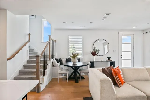 a dining room with furniture and wooden floor