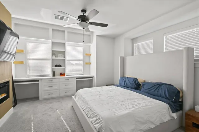 a living room with furniture a mirror and a wooden floor