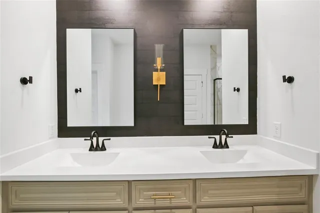 a bathroom with a double vanity sink and a mirror