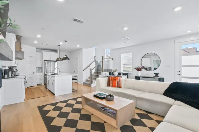 a living room with furniture and kitchen view