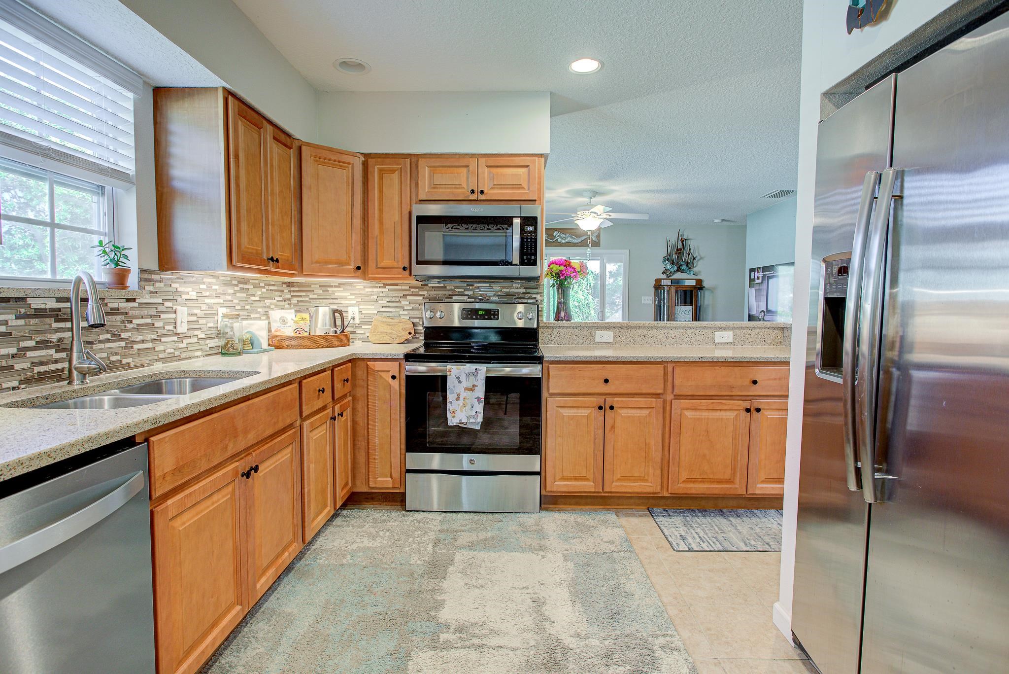 292 North Twin Maple Road St. Augustine, FL 32084 - Photo 25 of 79 a kitchen with stainless steel appliances granite countertop a stove top oven a refrigerator and a sink