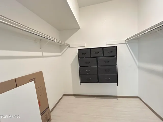 a view of an empty room with cabinet and a window