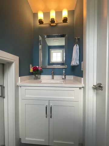 a bathroom with a sink a vanity and a mirror