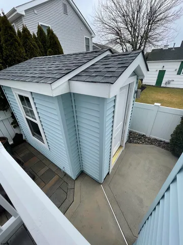a view of a house with a backyard