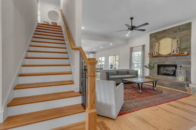 a living room with furniture and a view of kitchen