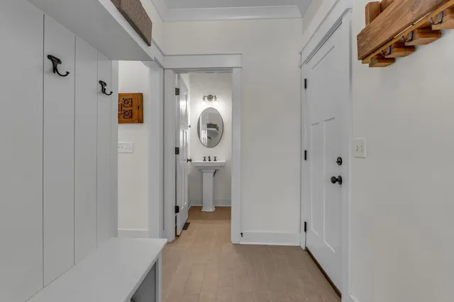 a bathroom with a sink and mirror with bathtub
