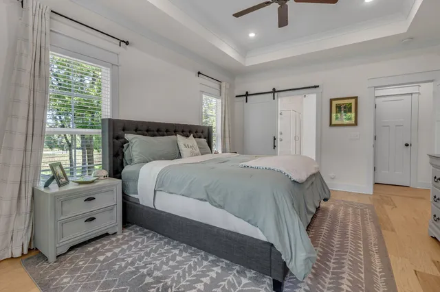 a bedroom with a bed and a chandelier