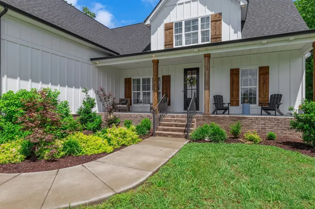 front view of a brick house with a yard