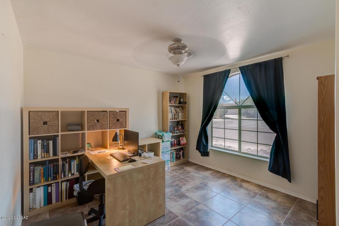 5311 West Fireopal Way Tucson, AZ 85742 - Photo 10 of 14 a view of a workspace with furniture and a book shelf