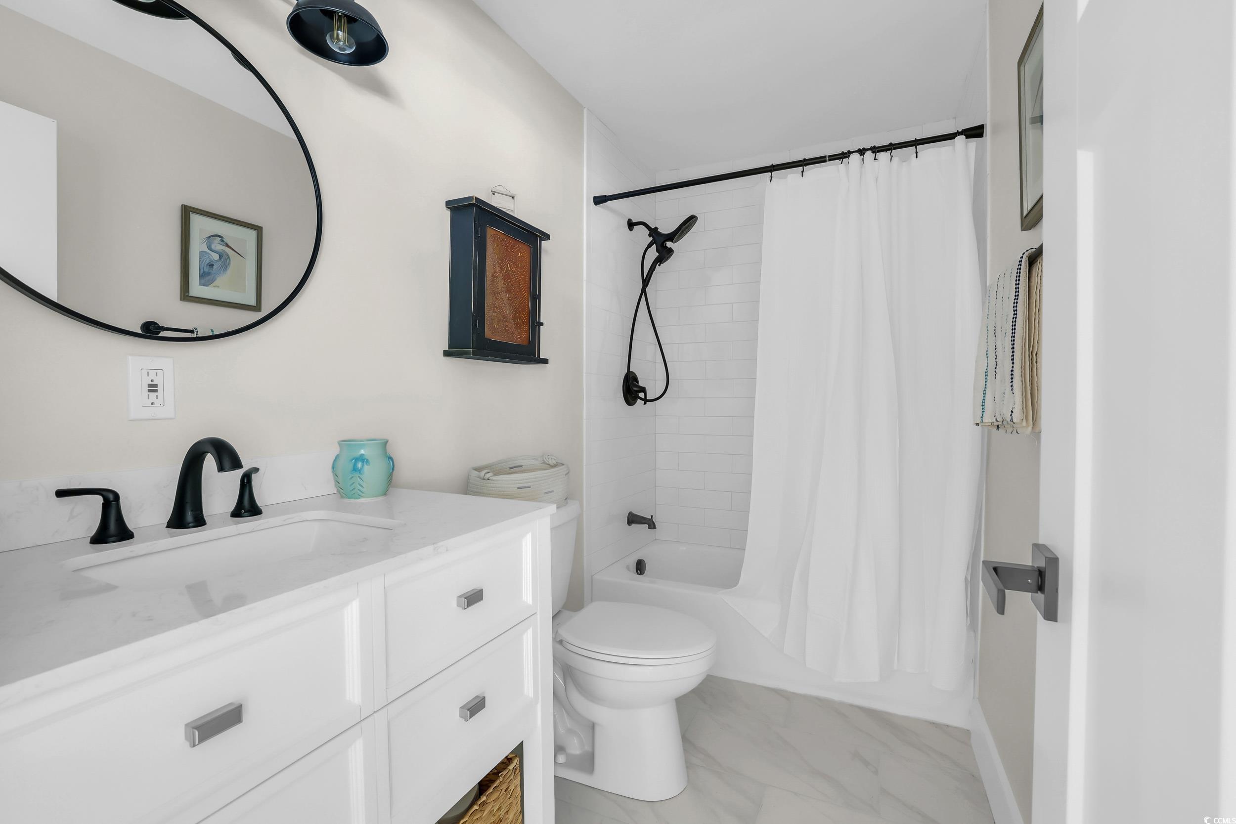 485 County Rd S-22-592 Georgetown, SC 29440 - Photo 17 of 40 Bathroom featuring vanity, marble look tiles, and shower / tub combo