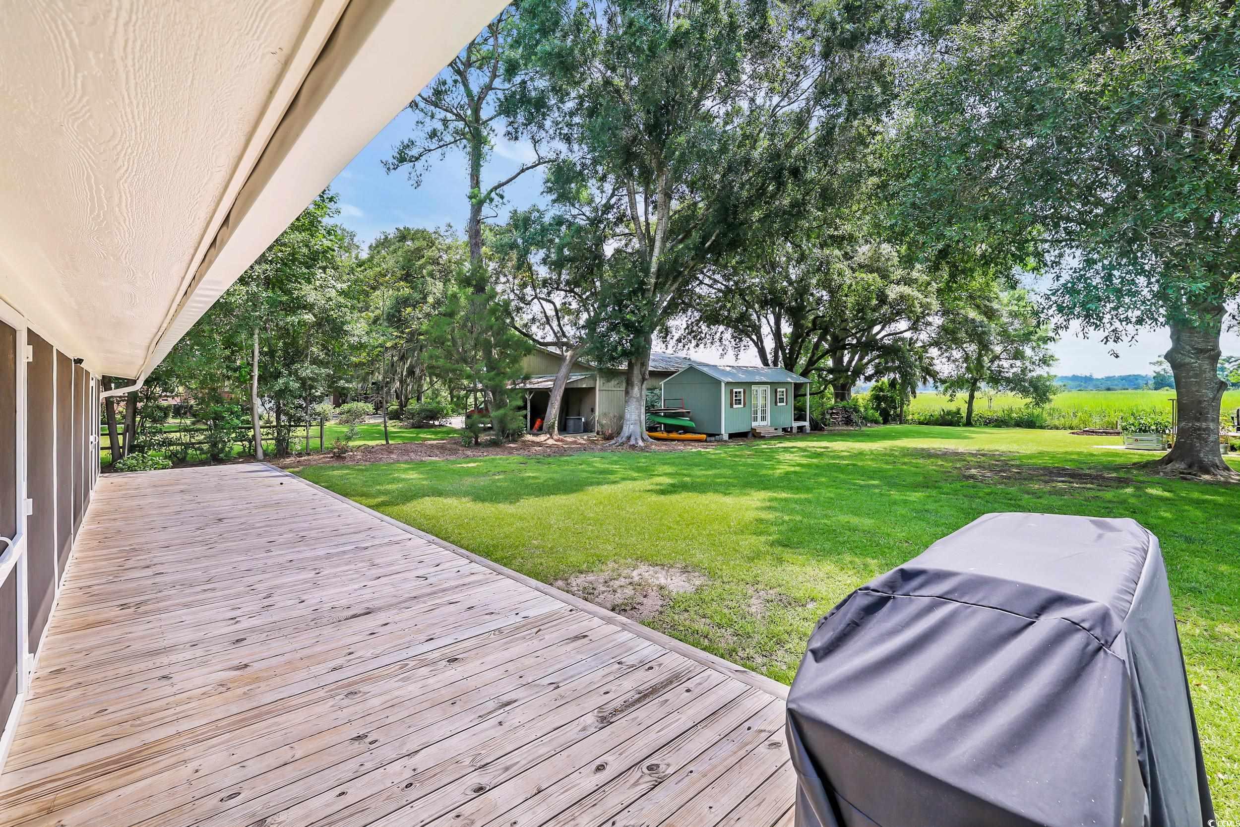 485 County Rd S-22-592 Georgetown, SC 29440 - Photo 26 of 40 Wooden terrace featuring a lawn