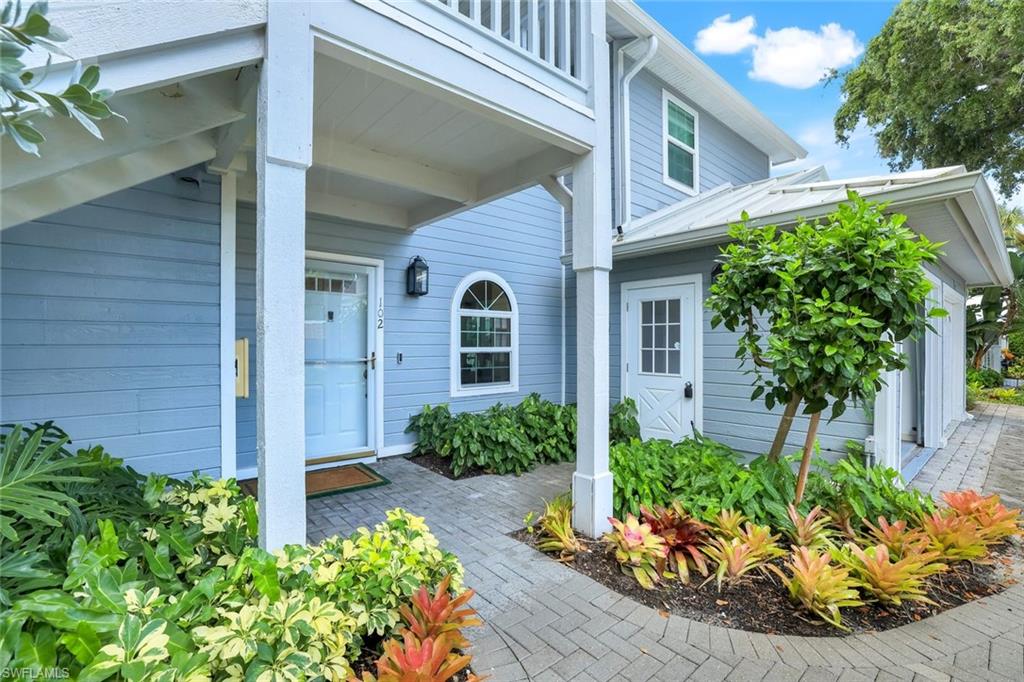 376 3rd Street South, Unit 102 Naples, FL 34102 - Photo 3 of 17 a front view of a house with a yard