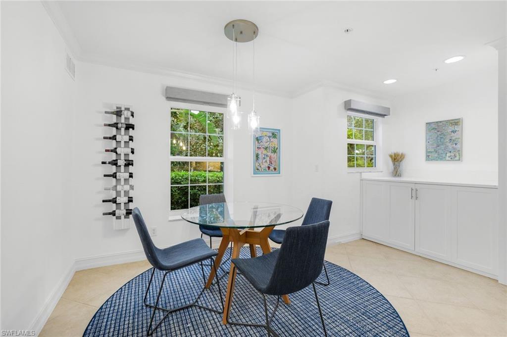 376 3rd Street South, Unit 102 Naples, FL 34102 - Photo 8 of 17 a view of a dining room with furniture and window