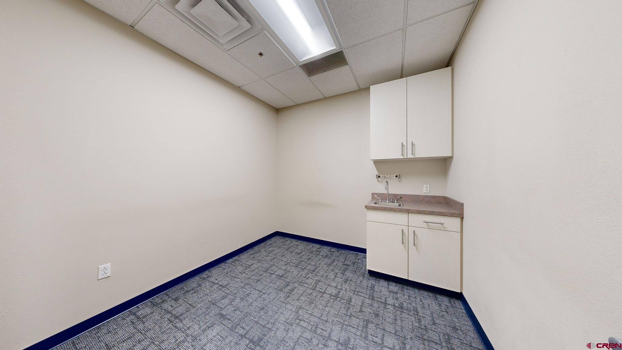 575 Rivergate Lane, Unit 208 Durango, CO 81301 - Photo 7 of 22 a view of a kitchen with white cabinets and wooden floor