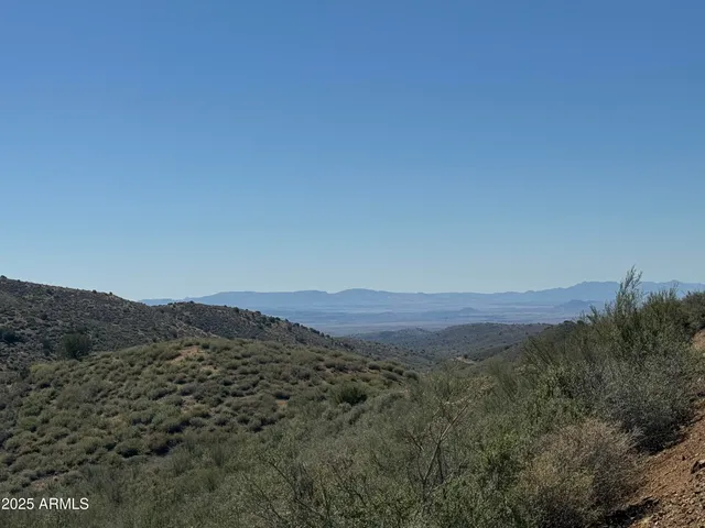 a view of a large mountain with mountains in the background