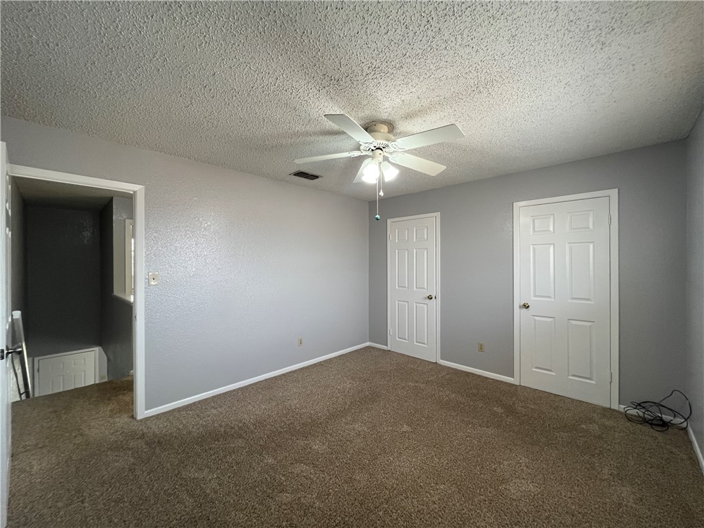 6533 Long Meadow Drive, Unit A Corpus Christi, TX 78413 - Photo 12 of 21 an empty room with fan and windows