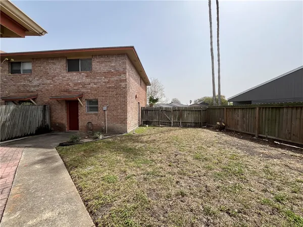 a view of a house with a backyard