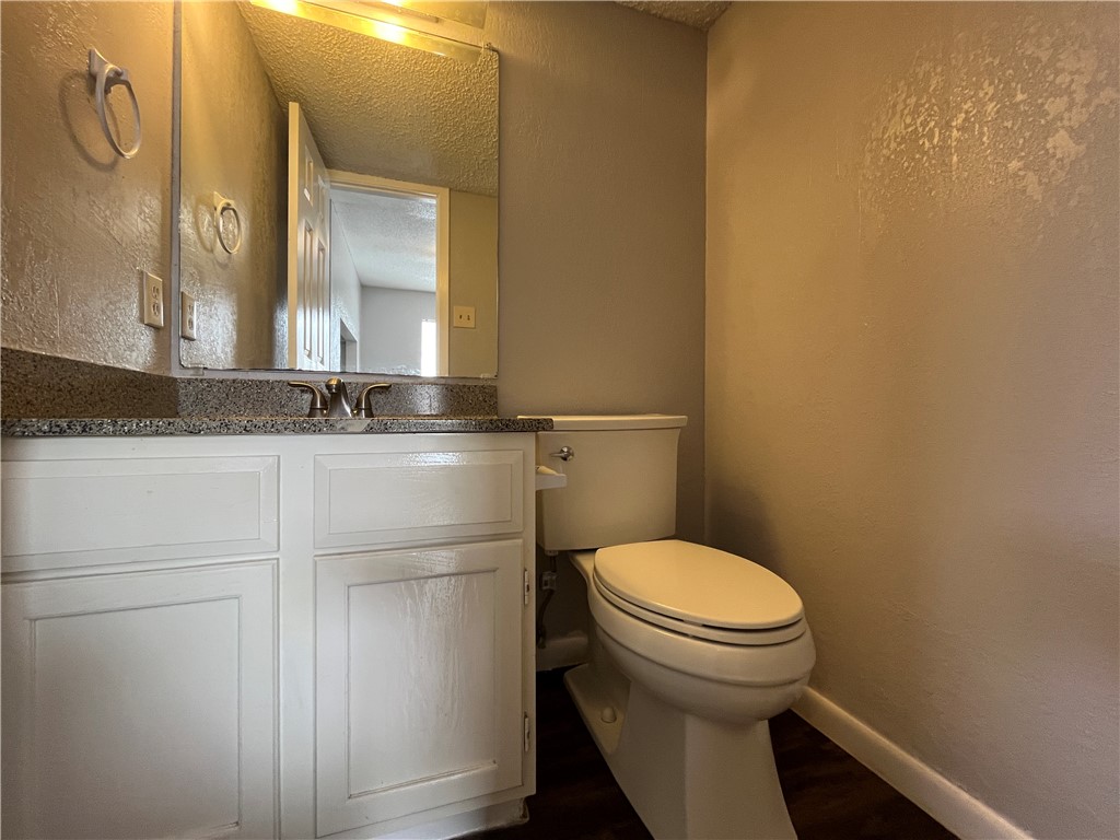 6533 Long Meadow Drive, Unit A Corpus Christi, TX 78413 - Photo 5 of 21 a bathroom with a granite countertop toilet and a sink