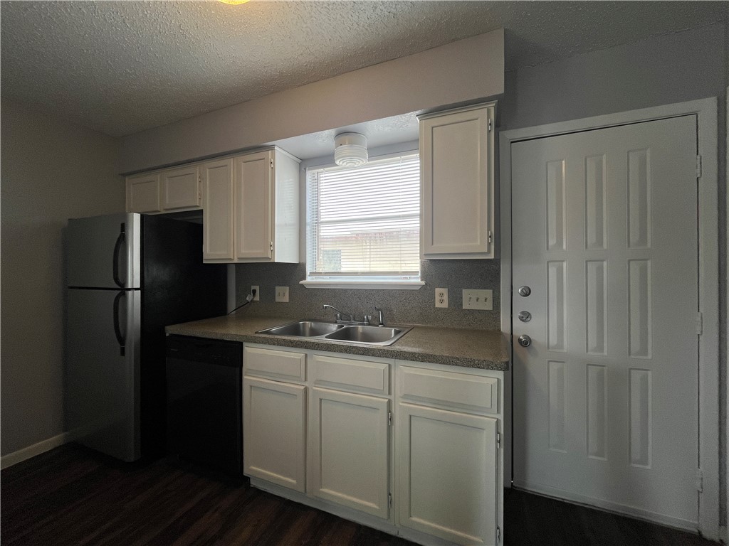 6533 Long Meadow Drive, Unit A Corpus Christi, TX 78413 - Photo 7 of 21 a kitchen with a sink a refrigerator and cabinets