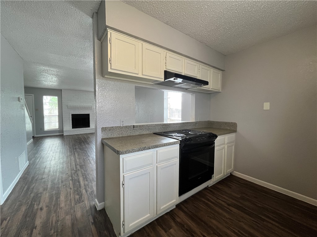 6533 Long Meadow Drive, Unit A Corpus Christi, TX 78413 - Photo 8 of 21 a kitchen with stainless steel appliances granite countertop a stove and a wooden floors