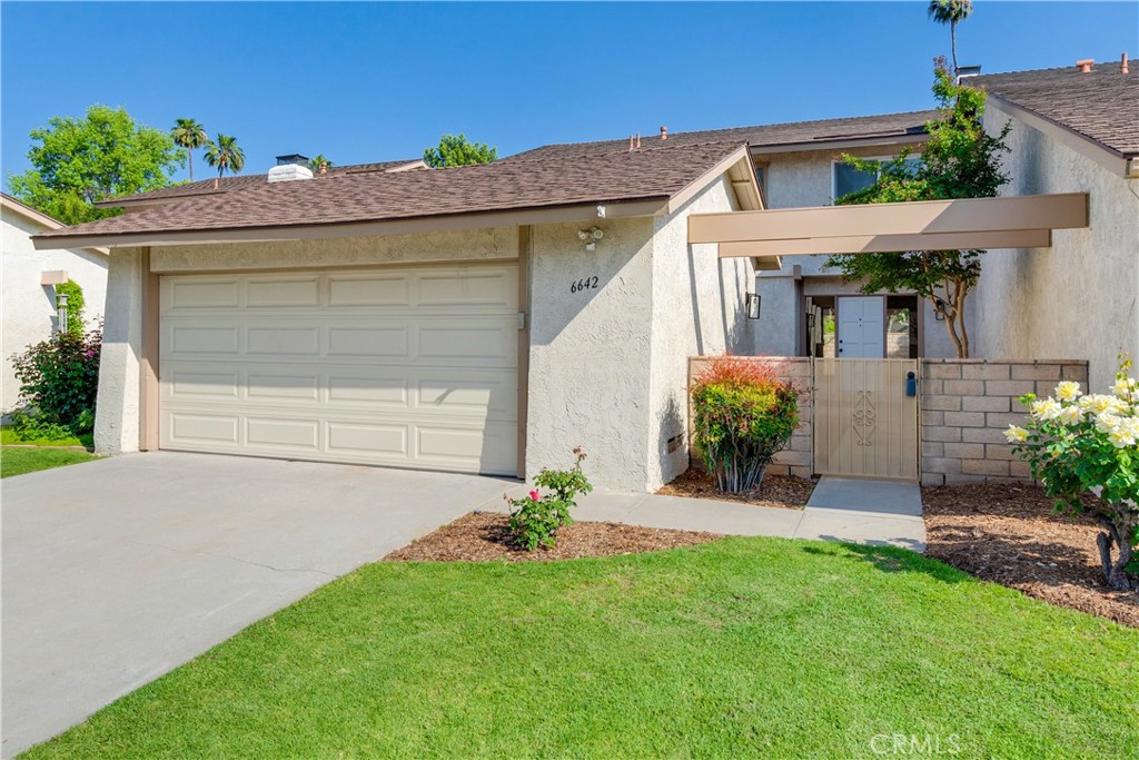 6642 Wintertree Drive Riverside, CA 92506 - Photo 1 of 1 a view of a house with brick walls and a yard with plants