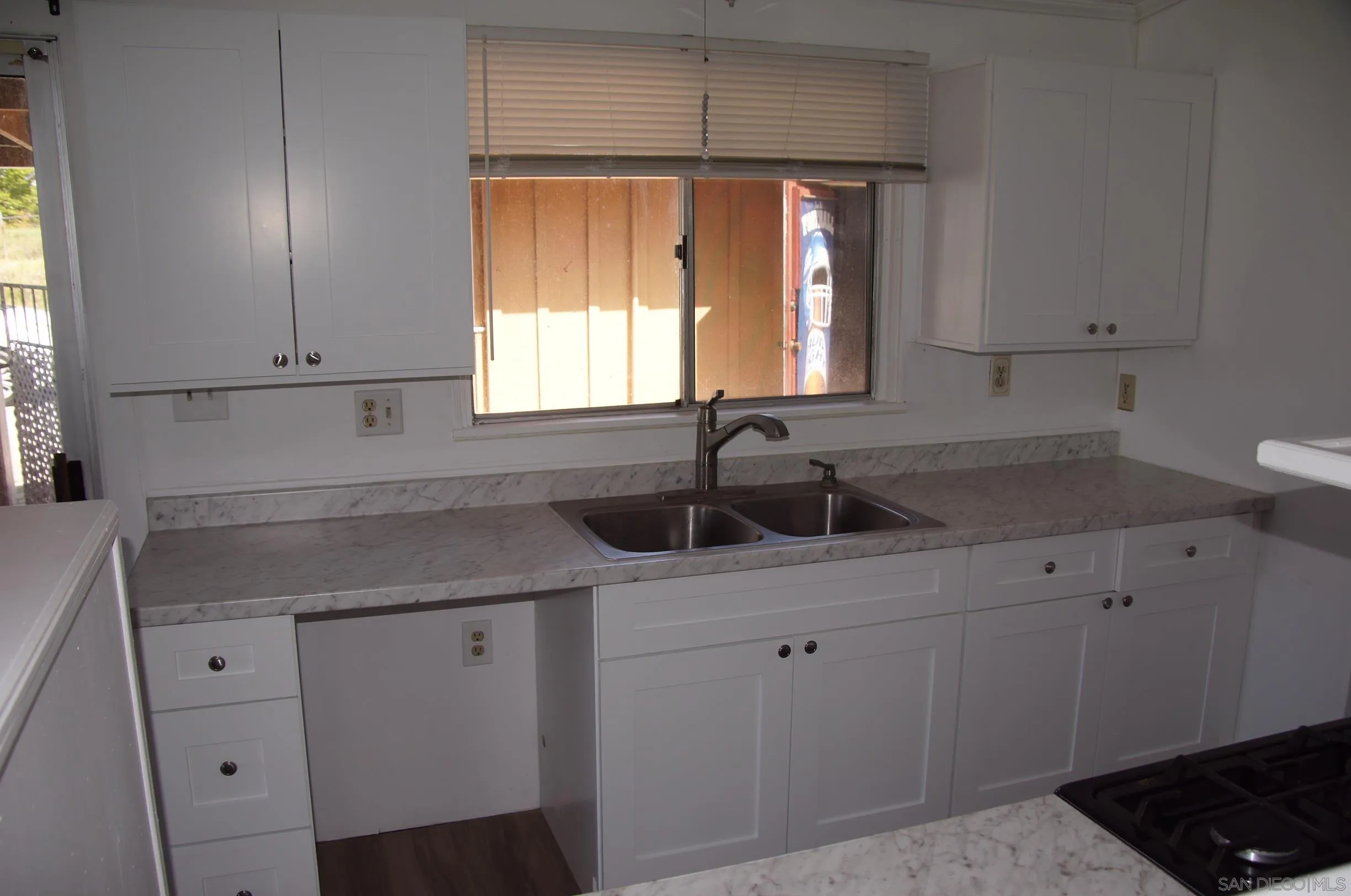 10088 Campo Road Spring Valley, CA 91977 - Photo 14 of 14 a kitchen with a sink cabinets and window