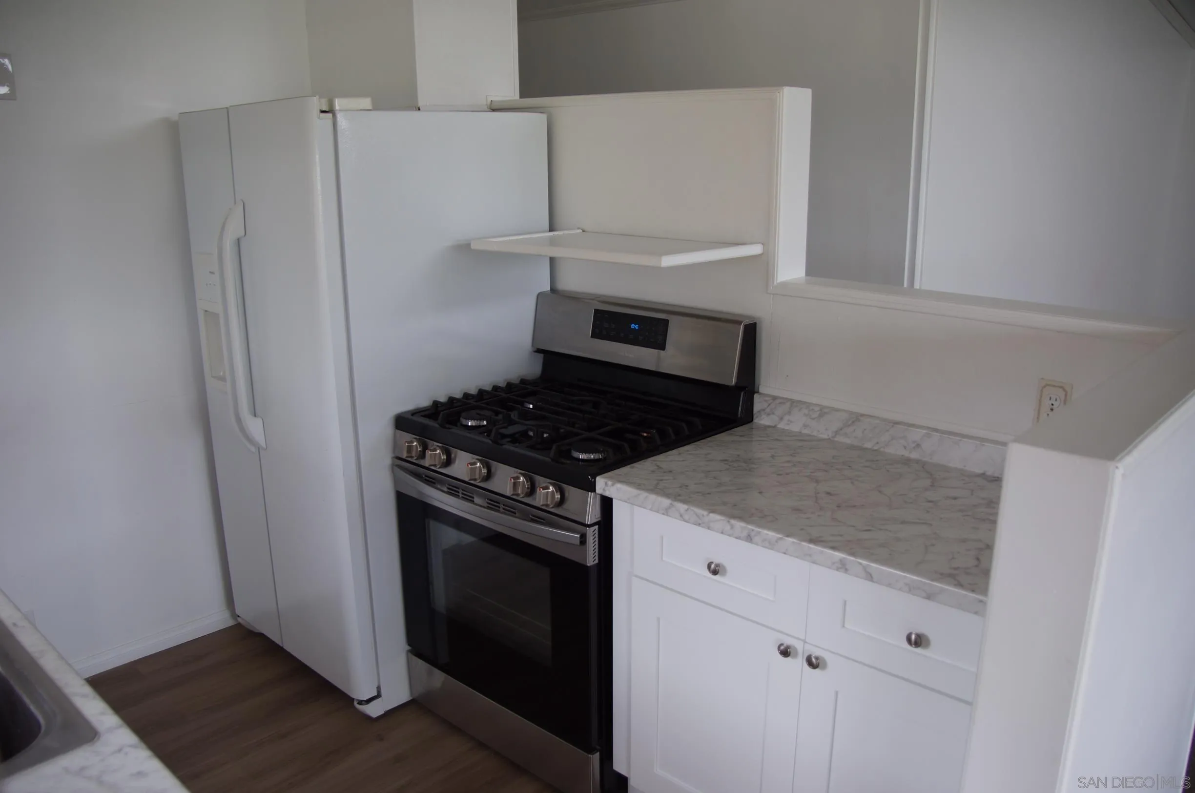 10088 Campo Road Spring Valley, CA 91977 - Photo 7 of 14 a kitchen with a stove and a refrigerator