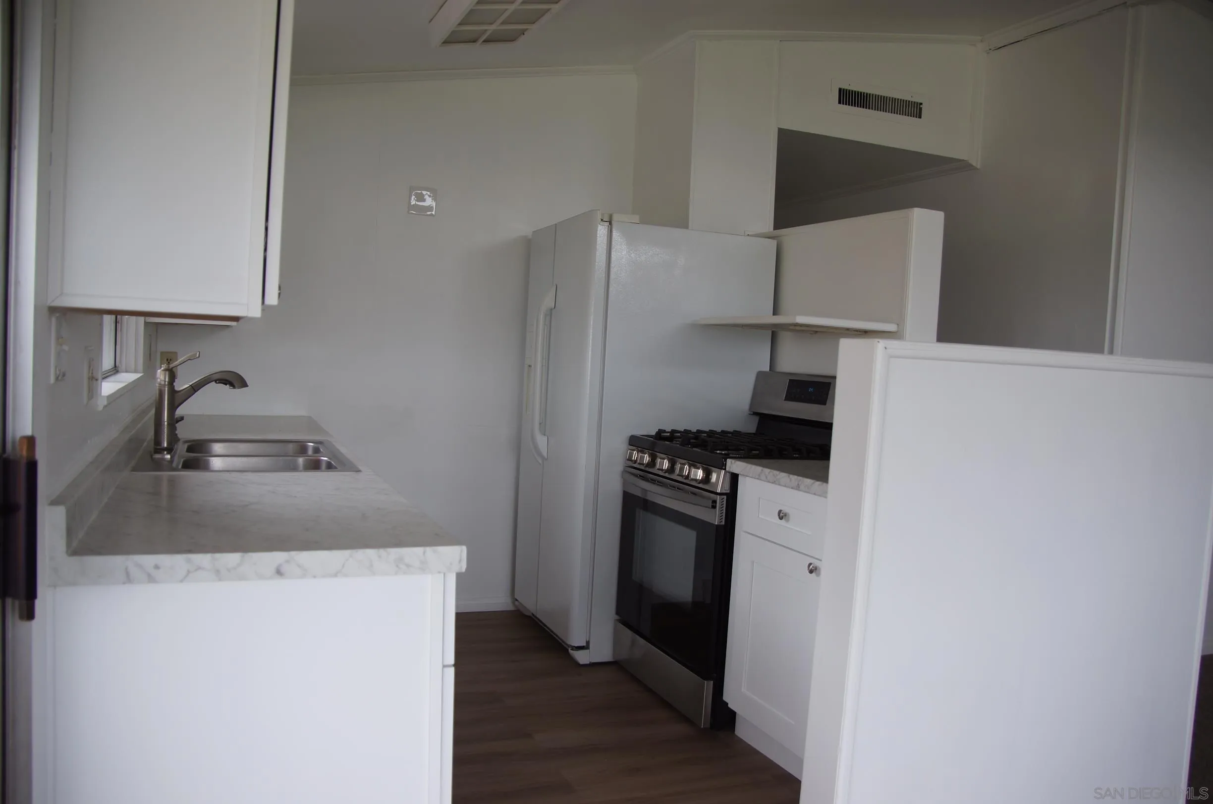 10088 Campo Road Spring Valley, CA 91977 - Photo 8 of 14 a kitchen with a refrigerator stove and a sink