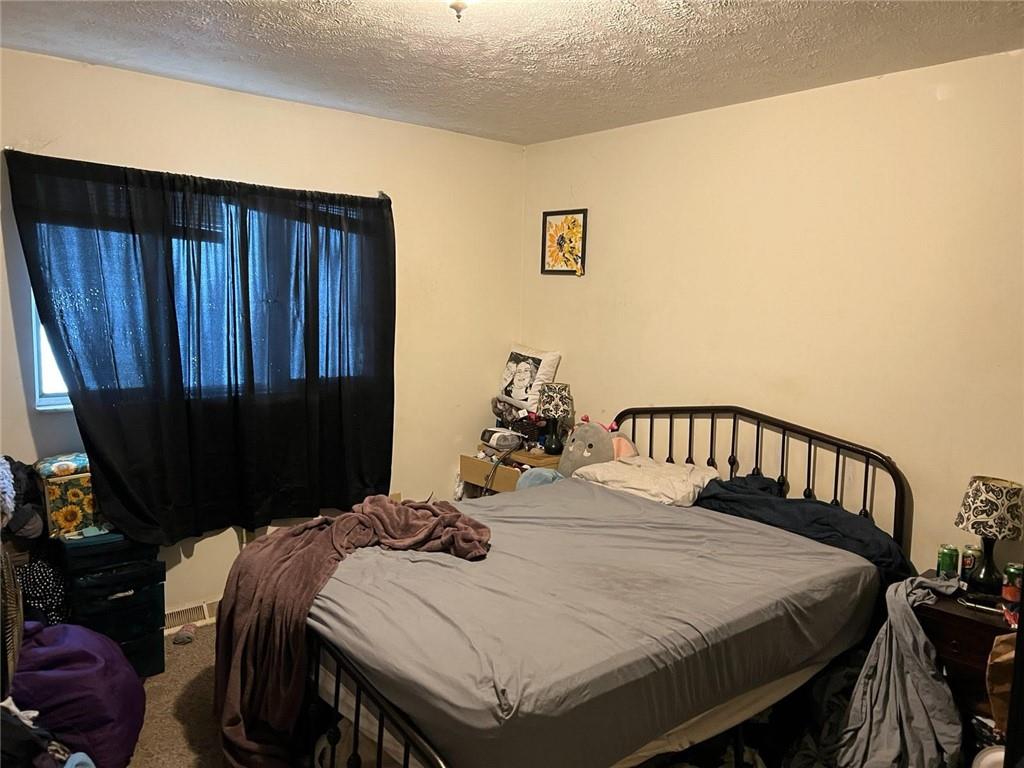 309 Magazine Street Carnegie, PA 15106 - Photo 13 of 18 a bed sitting in a bedroom next to a window