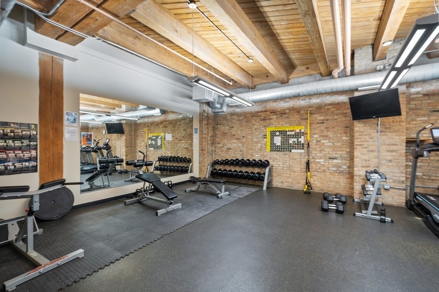 1040 West Adams Street, Unit 239 Chicago, IL 60607 - Photo 9 of 12 a view of a room with gym equipment
