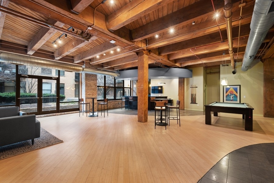 1040 West Adams Street, Unit 239 Chicago, IL 60607 - Photo 10 of 12 a view of a studio with wooden floor