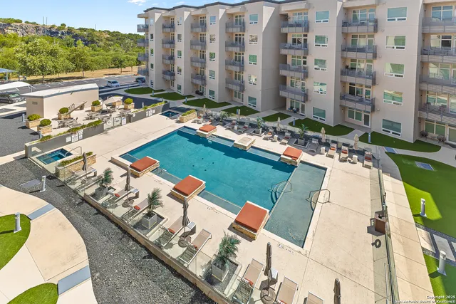 a view of swimming pool with outdoor seating