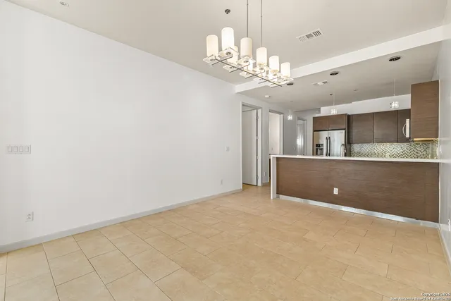 a view of a kitchen with a sink and chandelier