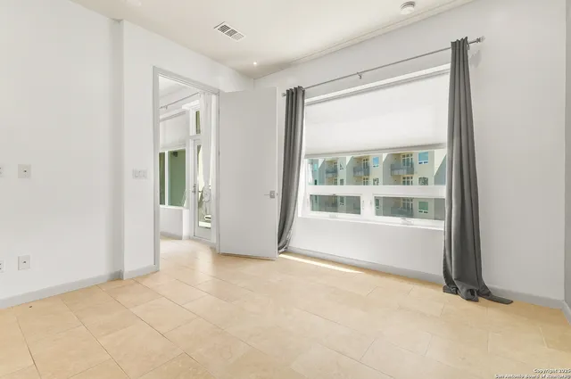 a view of an empty room with a window