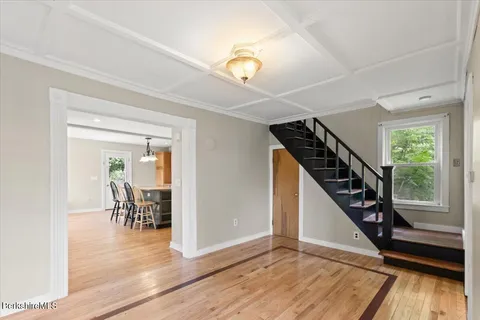 a view of a livingroom with wooden floor and furniture