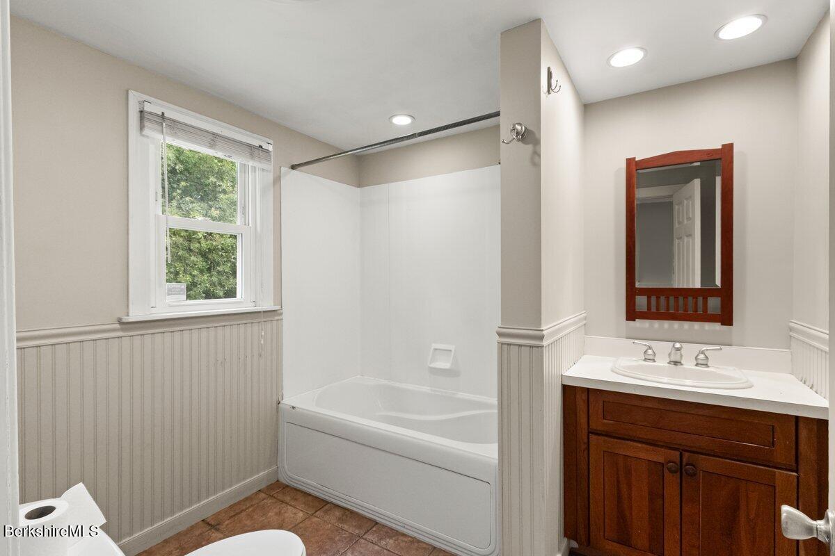 97 Barth Street North Adams, MA 01247 - Photo 21 of 31 a bathroom with a bathtub shower sink and a mirror