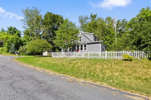 a house with swimming pool in front of it