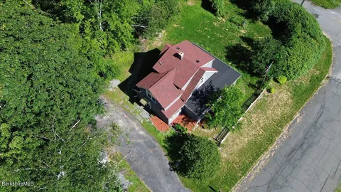 an aerial view of a house with a yard