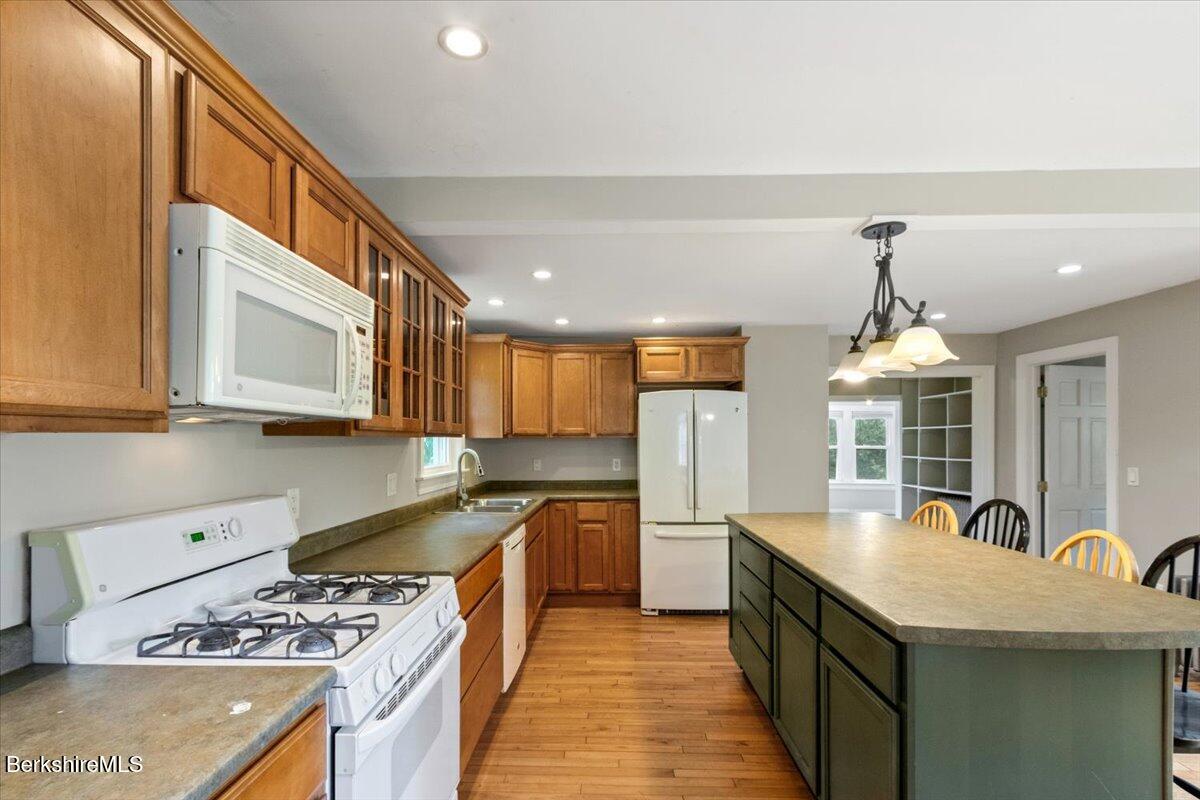 97 Barth Street North Adams, MA 01247 - Photo 6 of 31 a kitchen with stainless steel appliances granite countertop a sink a stove and a wooden cabinets