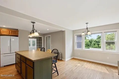a view of a kitchen with a sink a window and dining table