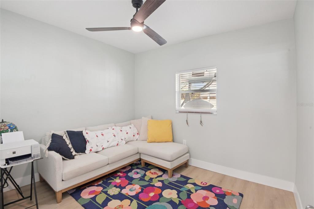 204 160th Avenue Redington Beach, FL 33708 - Photo 18 of 32 a living room with furniture and a baby crib