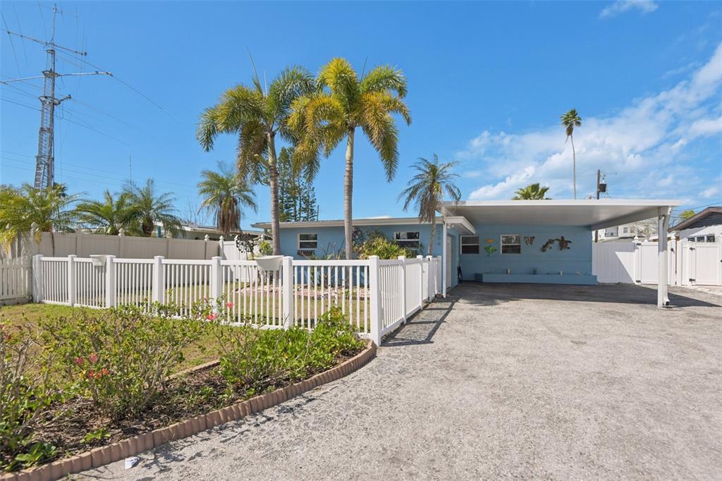 204 160th Avenue Redington Beach, FL 33708 - Photo 27 of 32 a front view of a house with a garden