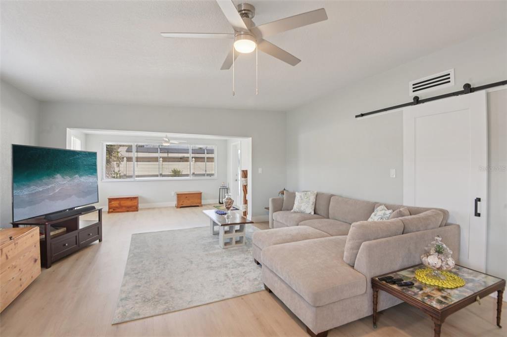204 160th Avenue Redington Beach, FL 33708 - Photo 9 of 32 a living room with furniture and a flat screen tv
