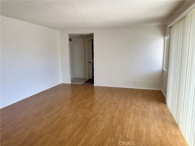 a view of an empty room and wooden floor