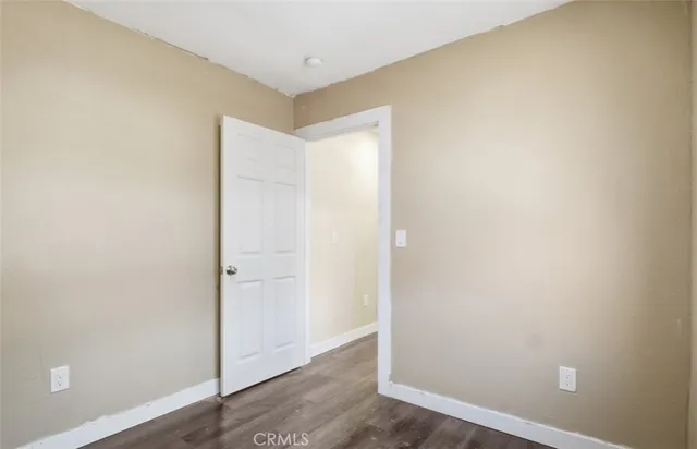 an empty room with wooden floor