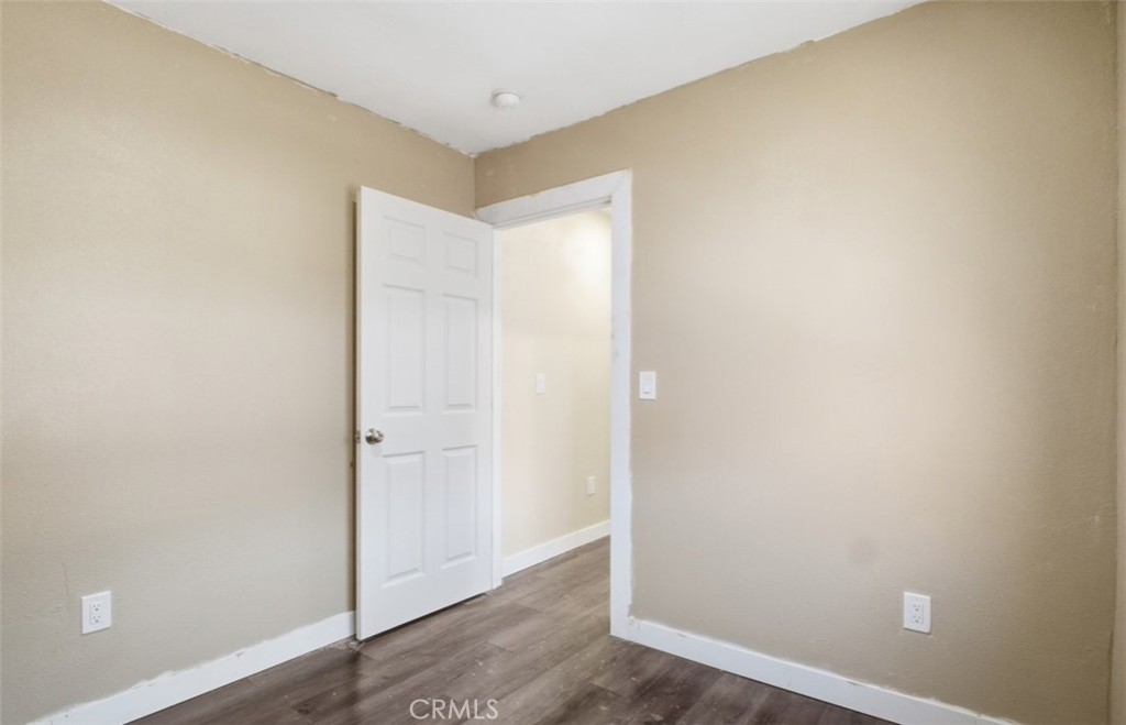 21719 Neptune Avenue Carson, CA 90745 - Photo 6 of 8 an empty room with wooden floor