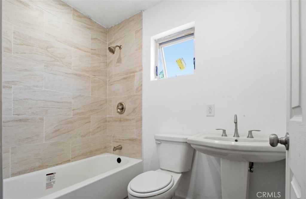 21719 Neptune Avenue Carson, CA 90745 - Photo 8 of 8 a bathroom with a sink a toilet and shower