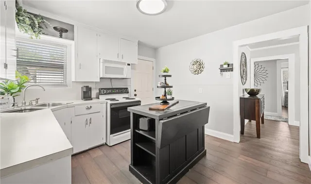 a kitchen with a stove sink and a refrigerator