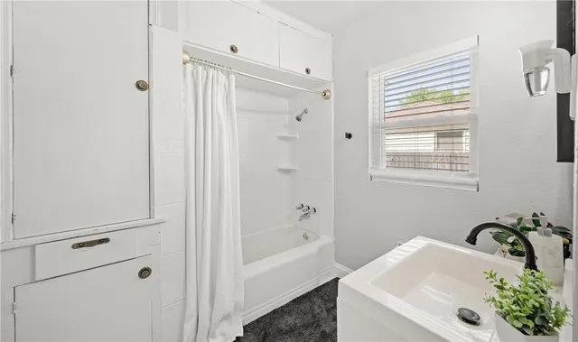 a bathroom with a tub sink and mirror