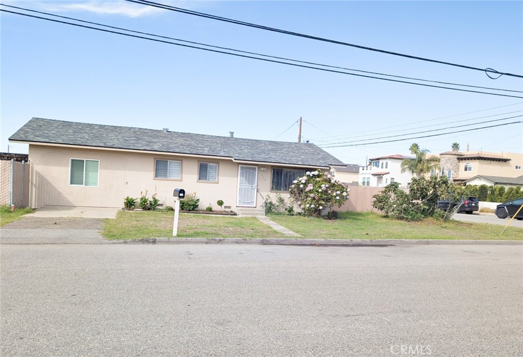 379 North 3rd Street Grover Beach, CA 93433 - Photo 1 of 24 a front view of a house with a yard and garage